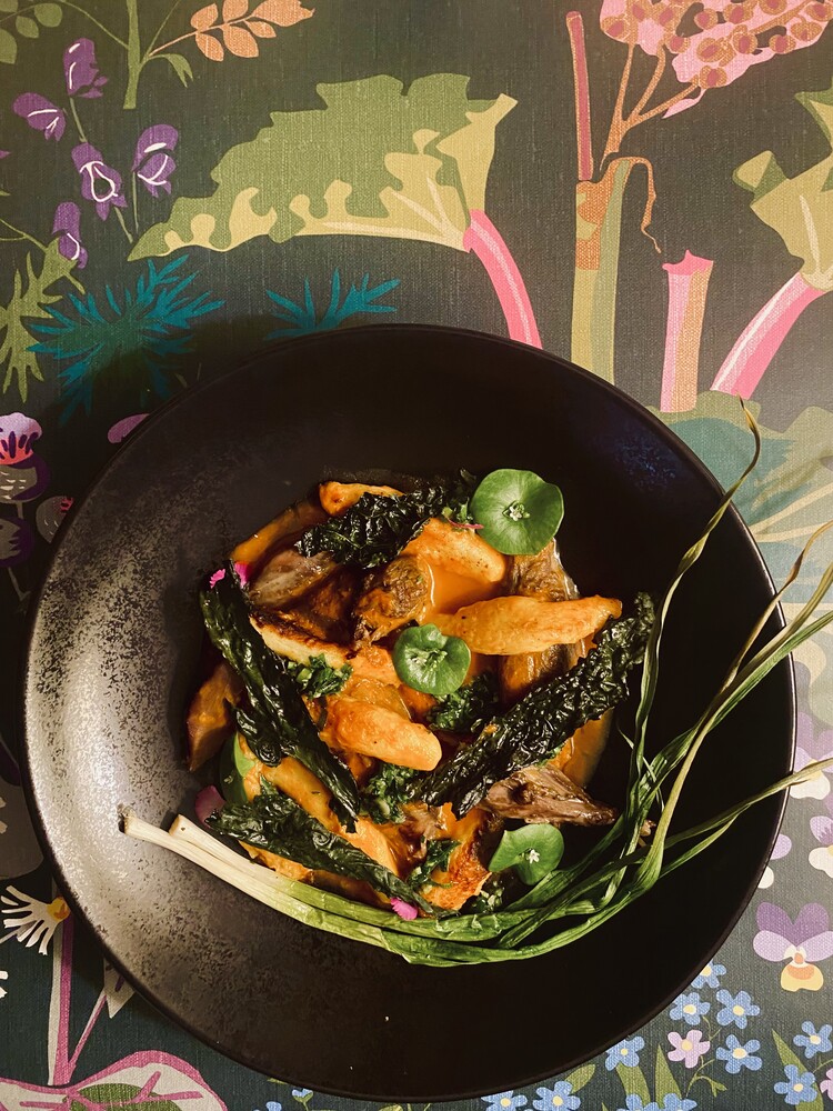 A plated Lustre dish on a floral table
